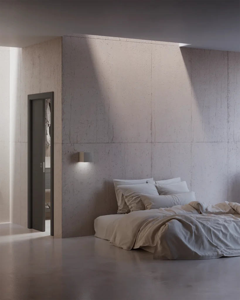 Porta della collezione Zero Phantos scorrevole interno muro, Soft antracite, inserita all'interno di una stanza materica dai toni neutri
