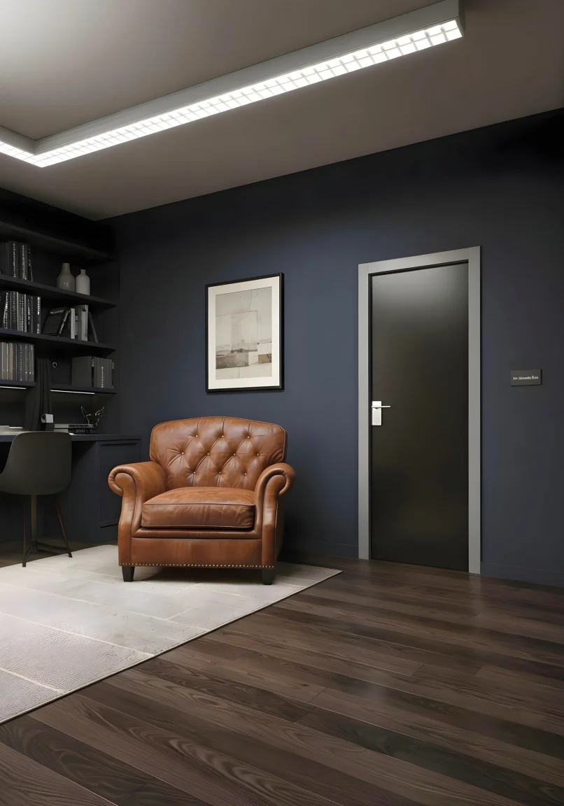 Porta della collezione Cristal con telaio laccato Soft Grigio e vetro bifacciale nero, inserita all'interno di uno studio sui toni del blu, nero e marrone.
